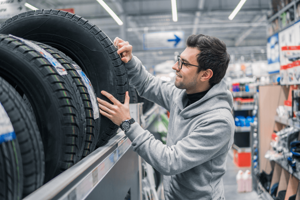 man-looking-at-tires-in-store