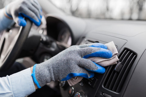 hands-wearing-gloves-cleaning-car-dash-interior