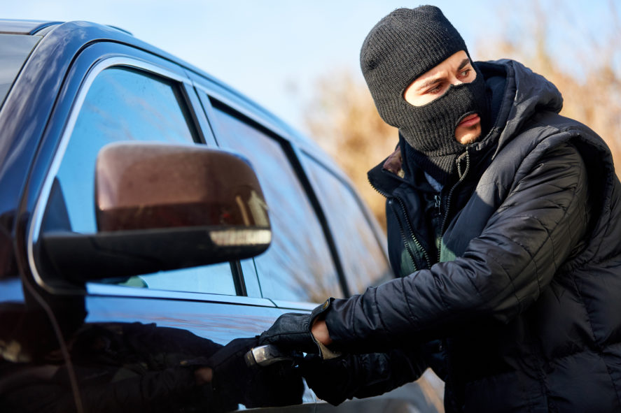 Car-Thief-Attempting-to-Break-Into-Car-Door